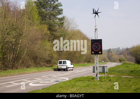 West Sussex England UK Wind powered 50 mph speed sign illuminated by vehicle on country main road Stock Photo