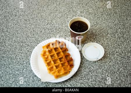 Light breakfast waffle on a takeaway paper plate and a cup of hot drink, London Covent Garden, Great Britain, UK Stock Photo