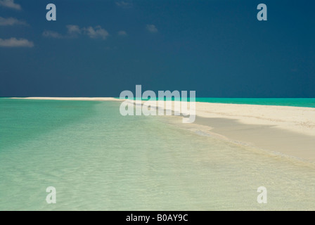 Sandspit blue lagoon blue skies white sandy tropical beach Kuramathi Island Maldives Stock Photo