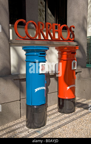 Red and blue post boxes outside post office in a street Funchal Madeira Portugal EU Europe Stock Photo