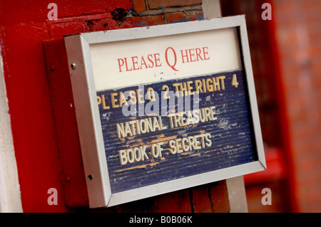 'Please queue here' an independent cinema entry sign in West Sussex. Picture by Jim Holden. Stock Photo