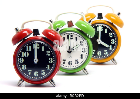 three classic small alarm clocks isolated on white background Stock Photo