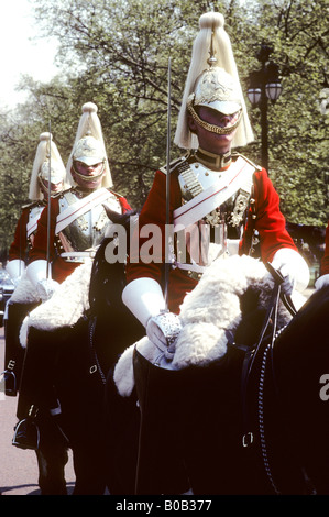 Horseguards in The Mall English British ceremonial army soldiers mounted horses horseback riders uniform red plumes plumed Stock Photo