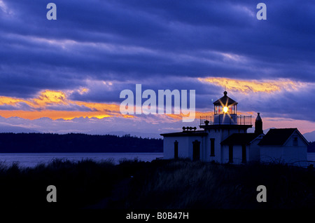 Lighthouse at western end of Discovery Park with Puget Sound in background Seattle Washington USA Stock Photo
