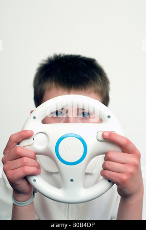 Boy Playing With Nintendo Wii Wheel Stock Photo