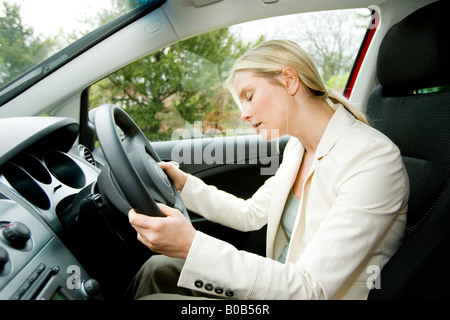 Woman falling asleep at while driving Stock Photo