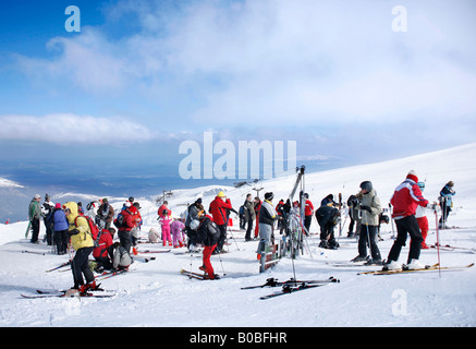 Skiers getting ready to go skiing at the top of Cairngorm Mountain Scotland Stock Photo