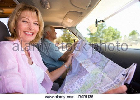 https://l450v.alamy.com/450v/b0bh36/mature-woman-with-map-in-motor-home-with-husband-smiling-portrait-b0bh36.jpg