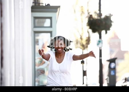 Young African American woman running on a street,  Georgetown, Washington, DC, USA, MR-4-16-08 Stock Photo