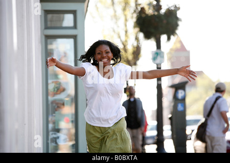 Young African American woman running on a street,  Georgetown, Washington, DC, USA, MR-4-16-08 Stock Photo