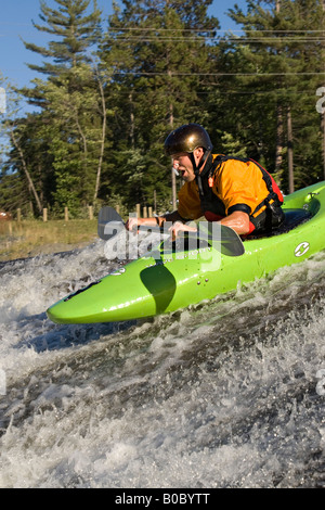 A whitewater kayaker descends a waterfall on the Dead River near Marquette Michigan Stock Photo