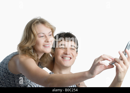 Close-up of a young couple using a mobile phone Stock Photo