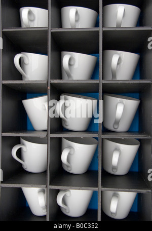 15 cups mugs dividend in too 5 rows off 3 in seperate little holes for each cup/mug taken closeup and from a birds eye view Stock Photo