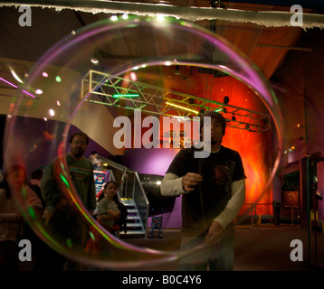 Man blowing a large soap bubble at the Pacific Science Center, Seattle, Washington, United States, North America. Stock Photo