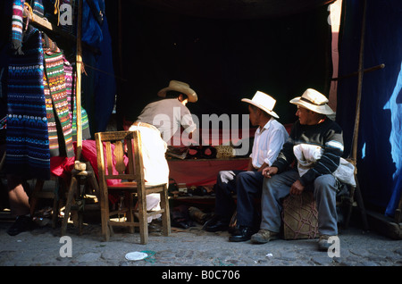 Elderly locals meet for a teatime chat at the weekly market in Chichicastenango in Guatemala. Stock Photo