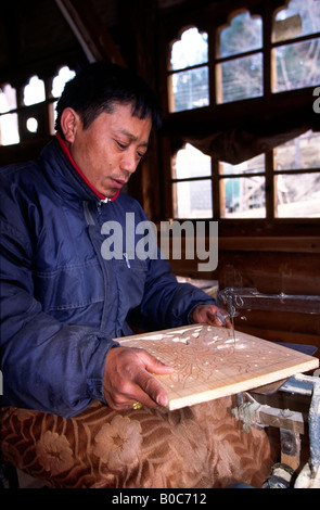 Bhutan Bumthang Valley Jakar crafts Udee Woodcarving bandsawing a panel Stock Photo