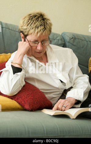 Mature middle aged woman reading a book Stock Photo