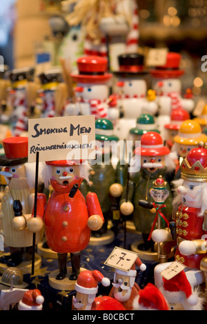 Smoking men ornaments on sale at a stall at the Christkindlmarkt (Christmas Markets) in downtown Salzburg, Austria, Europe. Stock Photo
