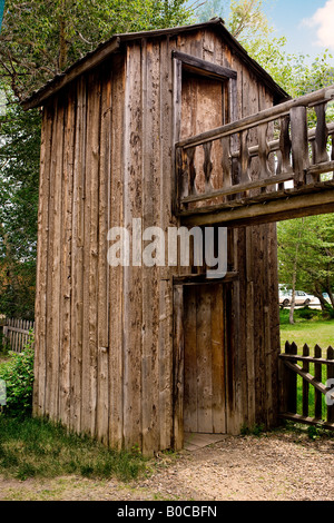 Image of the two story wooden outhouse that is attached to the blacksmith shop in Nevada City Montana Stock Photo