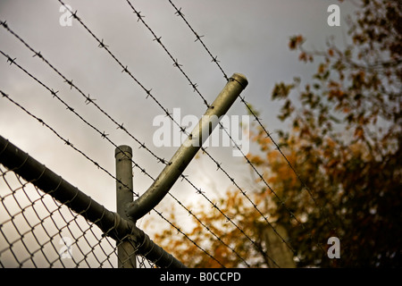 Barbed wire on top of chainlink fence Stock Photo