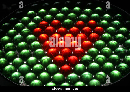 Red marbles one green marble hi-res stock photography and images - Alamy
