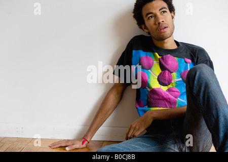 young man sitting on floor Stock Photo