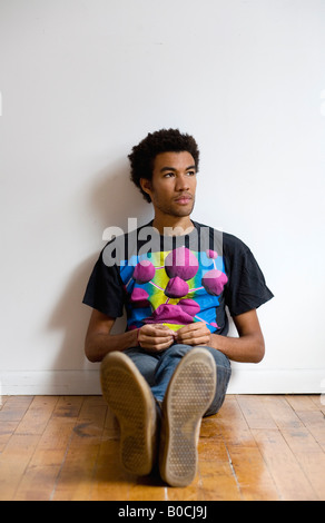 young man sitting on floor Stock Photo