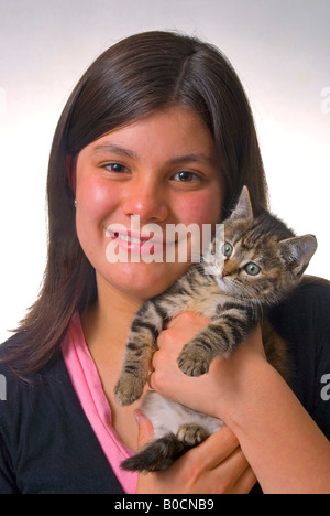 Long haired cute 11 year old girl with kitten Stock Photo