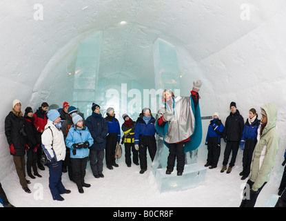Visitors listen to the guide on a guided tour inside the Jukkasjarvi icehotel in northern Sweden Stock Photo