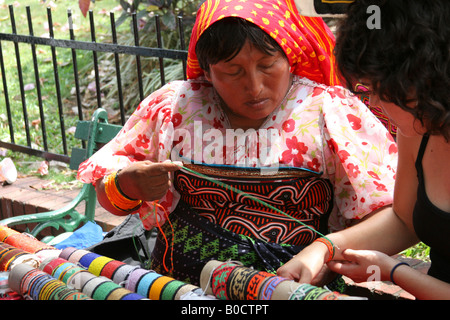 Kuna indian woman selling chaquiras at a street market of Panama City.  For Editorial Use Only. Stock Photo