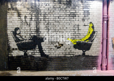 Banana and man recline in office - an image from The Cans Festival, a London street exhibition Banksy helped to open Stock Photo