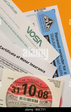 UK car motoring vehicle documents including car insurance car MOT car road tax and car sorn form Stock Photo