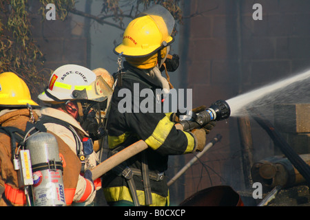 Firefighters fighting fire Stock Photo