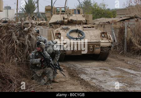 U S Army soldiers with Bravo Company 3rd Battalion 8th Cavalry Regiment wait for orders to conduct a house search. Stock Photo