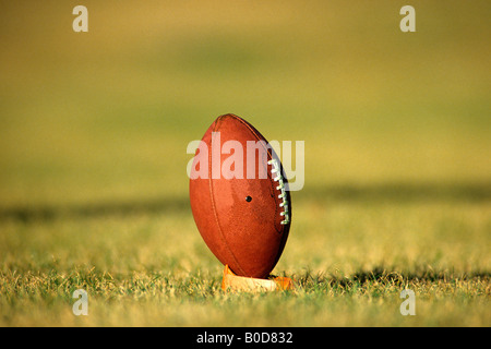 American football on kicking tee. Stock Photo