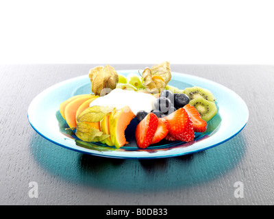 Plate of Mixed Fruit Salad with Low Fat Yogurt Stock Photo