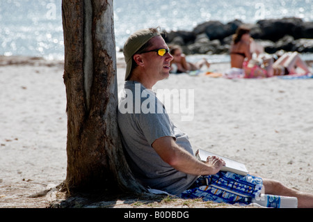 Young man reading a book on Fort Zachary Taylor Beach in Key West Florida USA Stock Photo