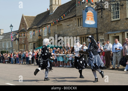 Pig Dykes Molly, morris dancers .May Fair Stilton village  High Street closed Bell Inn sign. Cambridgeshire UK 2000s 2008 UK HOMER SYKES Stock Photo