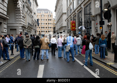 Onlooking londoners watching international TV reports on the failed Haymarket car bombing in central london, June 2007 Stock Photo