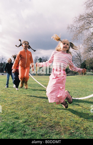 Primary school children jumping rope Stock Photo - Alamy