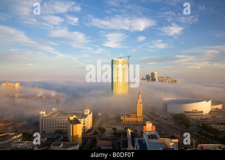 Aerial view of a foggy downtown Miami without a horizon, the sky is endless in a rainbow of colors. Where the clouds end and the mist starts? Unknown. Stock Photo