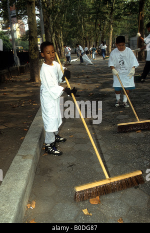 Volunteers sweep the paths at Sara Delano Roosevelt Park in New York during the annual Clean Up the World Day Stock Photo