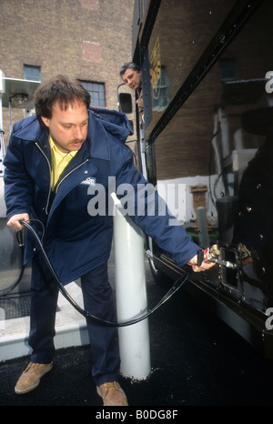 Con Edison worker refuels UPS delivery truck at their compressed natural gas refueling station in New York Stock Photo