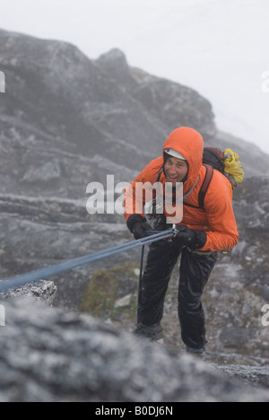 Climber rappelling into the fog on The Throne, Little Switzerland, Pika Glacier, Alaska Stock Photo