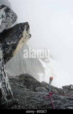 Climber rappelling into the fog on The Throne, Little Switzerland, Pika Glacier, Alaska Stock Photo