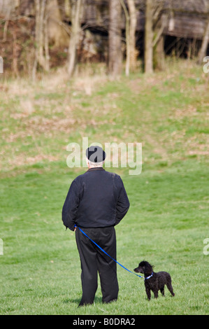Man Standing in Cherokee Park with Small Dog on Leash Louisville Kentucky Stock Photo