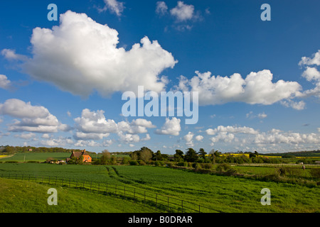 Rural cottage fields and a beautiful cloud filled sky Knowlton Dorset England Stock Photo