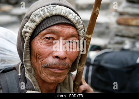 portrait of old nepali man with stick annapurna nepal Stock Photo