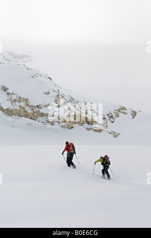 Two skiers skinning up the Seven Steps of Paradise, Rogers Pass, Asulkan Glacier, Selkirk Mountains, British Columbia, Canada Stock Photo