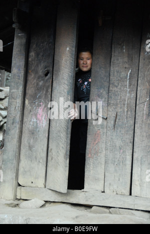 black hmong lady behind close door, sin chi Stock Photo